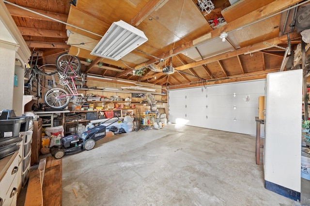 garage with a garage door opener and a workshop area