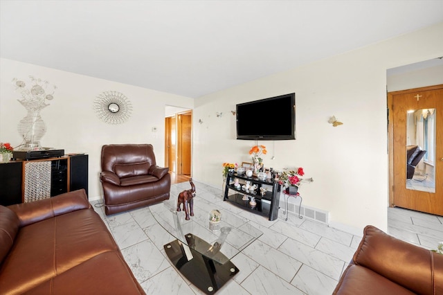 living area with marble finish floor, visible vents, and baseboards