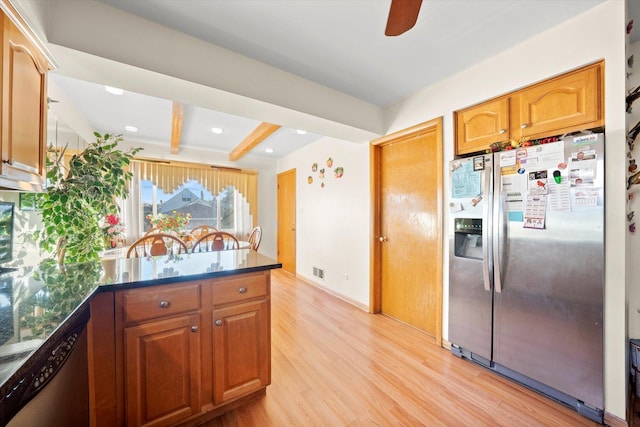 kitchen featuring appliances with stainless steel finishes, visible vents, beam ceiling, light wood-type flooring, and a peninsula
