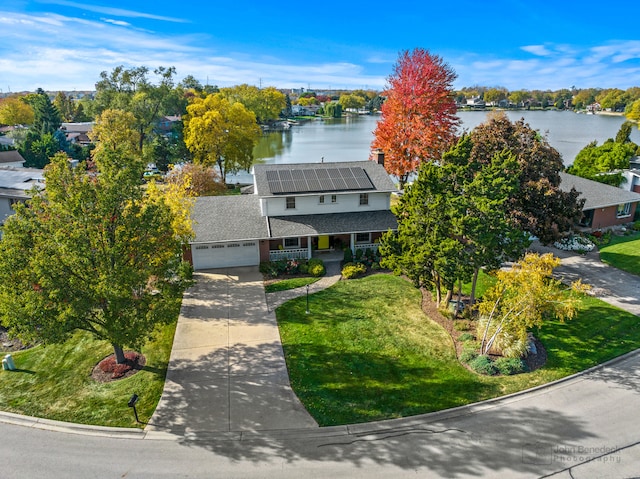 birds eye view of property with a water view