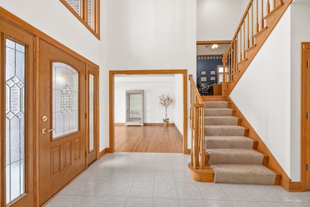 entrance foyer featuring light tile patterned flooring and a high ceiling