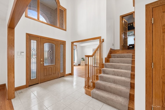 foyer featuring a high ceiling and light tile patterned floors