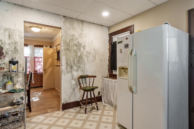 kitchen with light hardwood / wood-style flooring and white fridge with ice dispenser