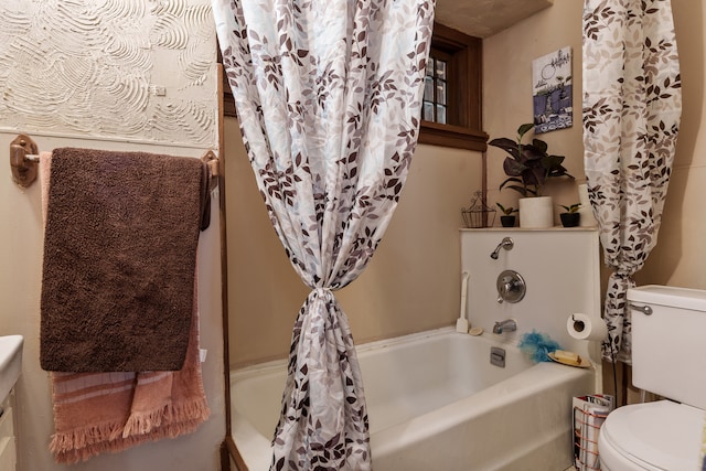 bathroom featuring shower / bath combination with curtain and toilet