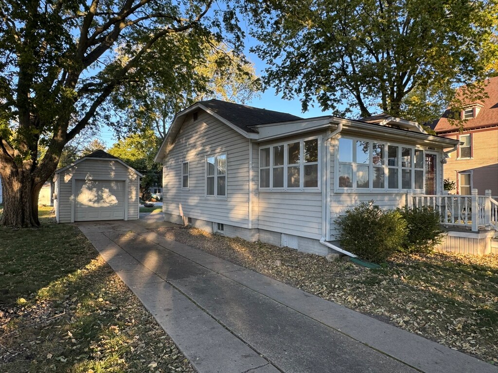 view of home's exterior with an outdoor structure and a garage