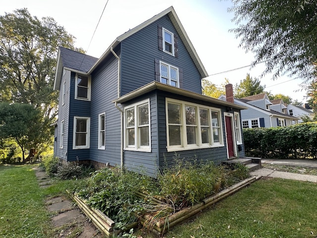 view of side of property with a yard