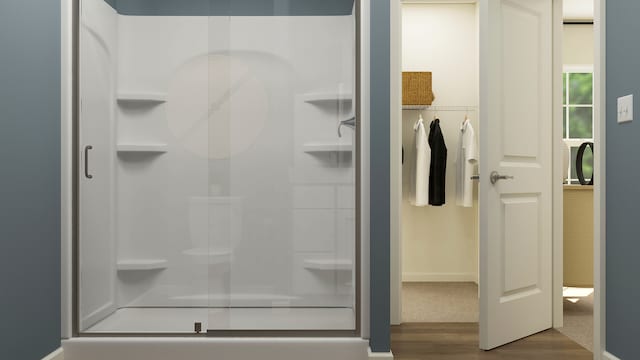 bathroom featuring walk in shower and hardwood / wood-style floors