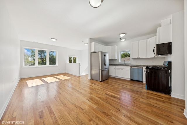 kitchen featuring light hardwood / wood-style floors, a healthy amount of sunlight, and black appliances