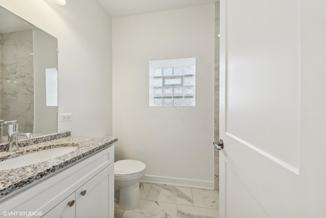 bathroom featuring baseboards, marble finish floor, vanity, and toilet