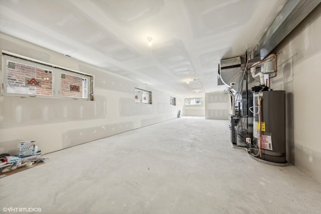 basement featuring water heater and heating unit