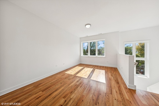 spare room with light wood finished floors and baseboards