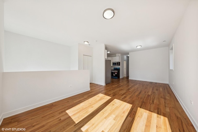 interior space featuring wood finished floors and baseboards
