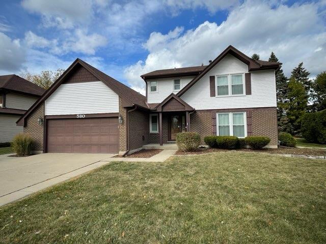 view of front of home featuring a garage and a front lawn