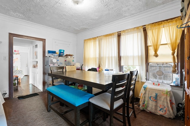 dining room featuring crown molding, a textured ceiling, and tile patterned floors