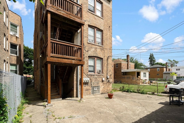 rear view of property featuring cooling unit and a patio