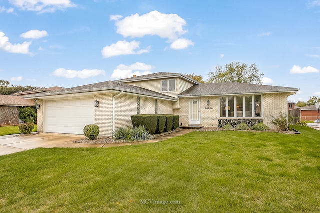 split level home featuring a front yard and a garage