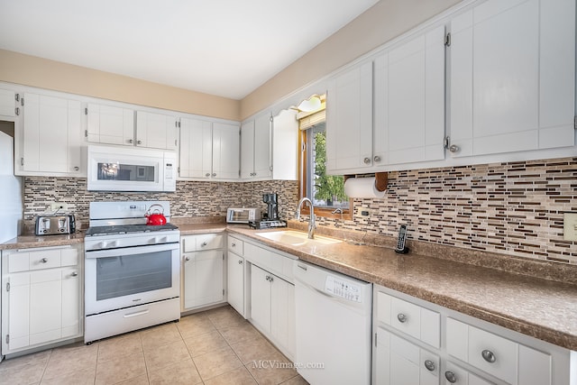 kitchen featuring sink, light tile patterned floors, white cabinets, white appliances, and tasteful backsplash