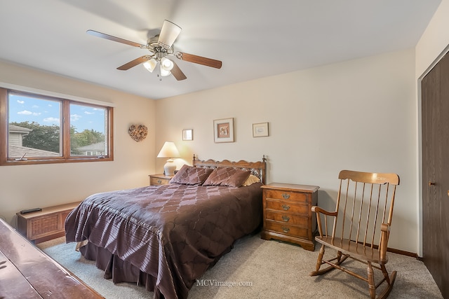 carpeted bedroom featuring a closet and ceiling fan