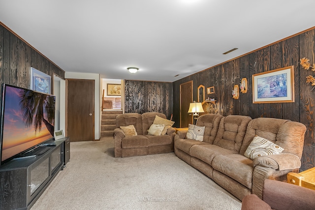 living room featuring wooden walls and light carpet