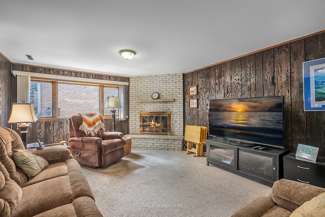 living room featuring wood walls, carpet floors, and a fireplace