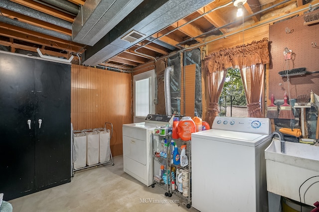 washroom with sink and washing machine and clothes dryer