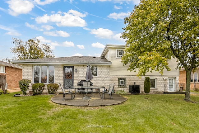 rear view of house with a patio area, central air condition unit, and a lawn