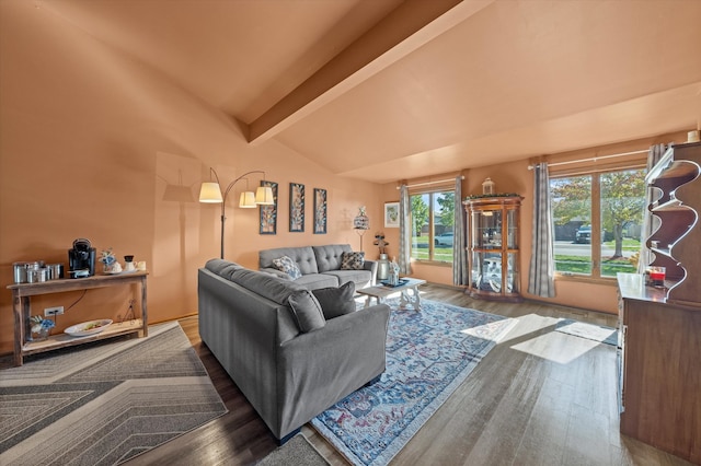 living room with lofted ceiling with beams and hardwood / wood-style flooring