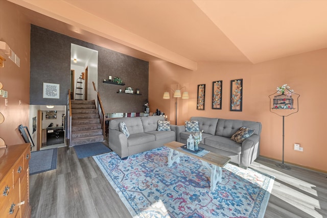 living room featuring vaulted ceiling with beams and dark hardwood / wood-style flooring