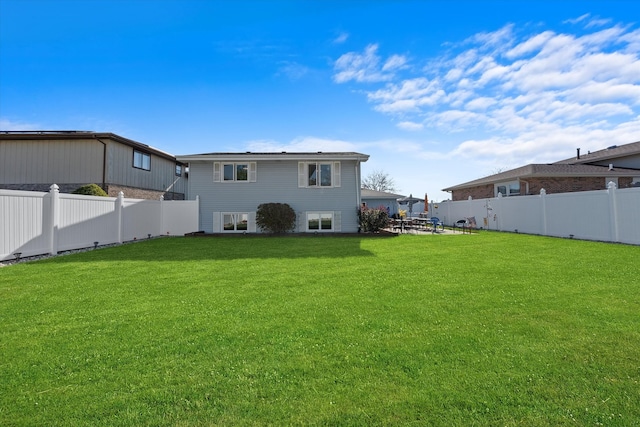 rear view of property featuring a yard