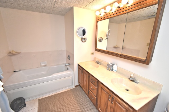 bathroom with vanity, tile patterned floors, and a washtub