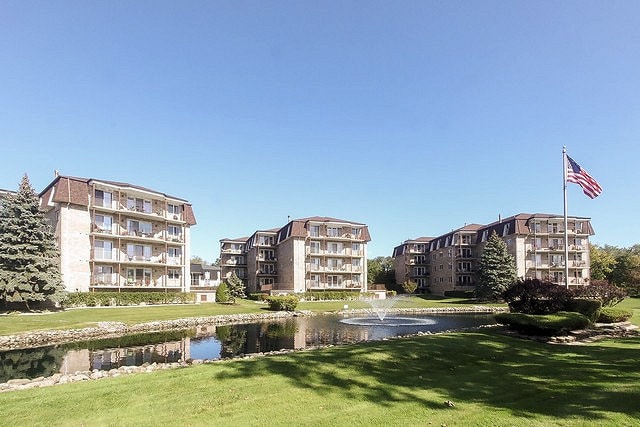 view of home's community featuring a yard and a water view