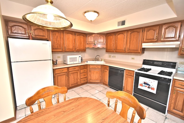 kitchen featuring backsplash, light tile patterned floors, pendant lighting, sink, and white appliances