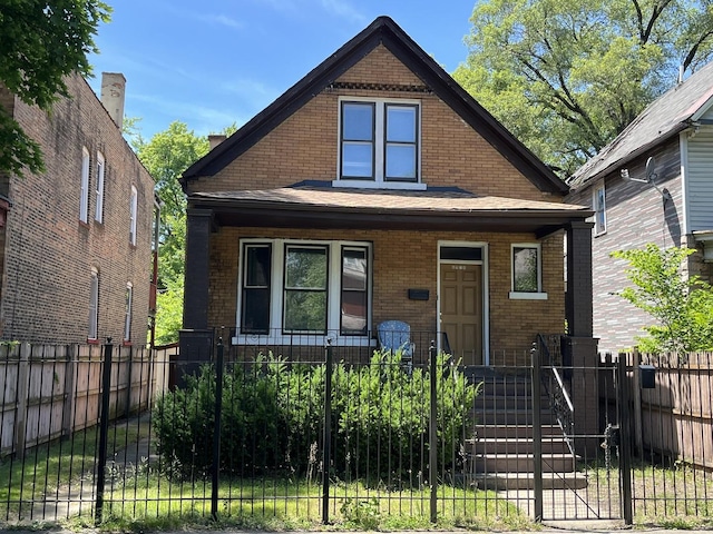6916 S Lowe Ave, Chicago, IL 60621 - bungalow-style house featuring brick siding, a fenced front yard, and a porch