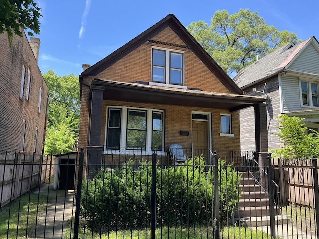 6916 S Lowe Ave, Chicago, IL 60621 - bungalow-style house with a gate, covered porch, a fenced front yard, and brick siding