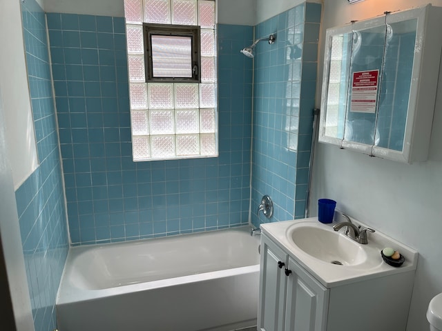 full bathroom featuring vanity, toilet, and tiled shower / bath combo