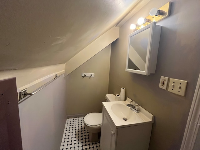 bathroom featuring toilet and vanity