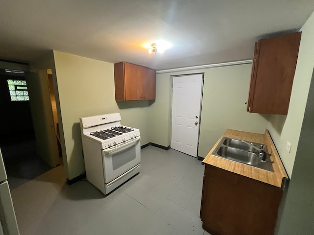 kitchen featuring sink and white gas range oven