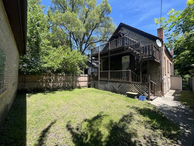 6916 S Lowe Ave, Chicago, IL 60621 - back of property featuring brick siding, a fenced backyard, a wooden deck, and a yard
