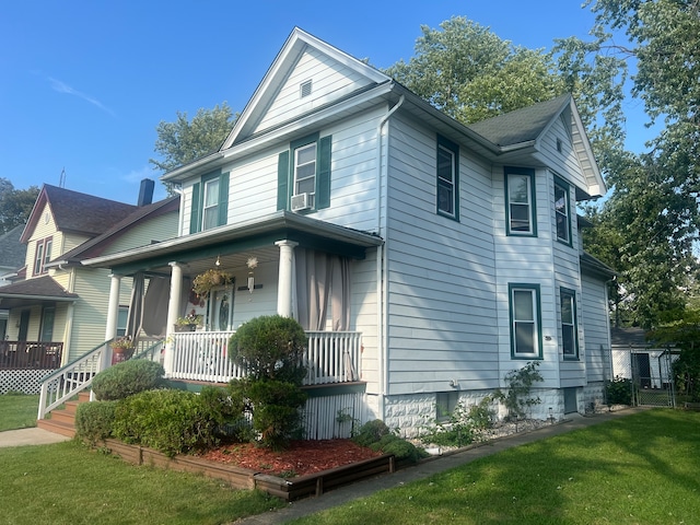 view of home's exterior with covered porch, a yard, and cooling unit