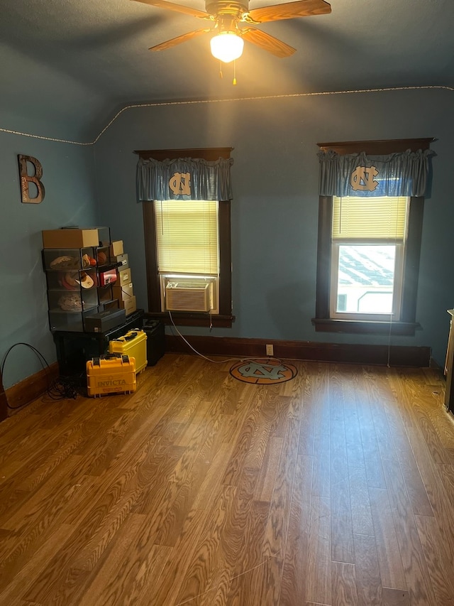 unfurnished bedroom with lofted ceiling, hardwood / wood-style flooring, and ceiling fan