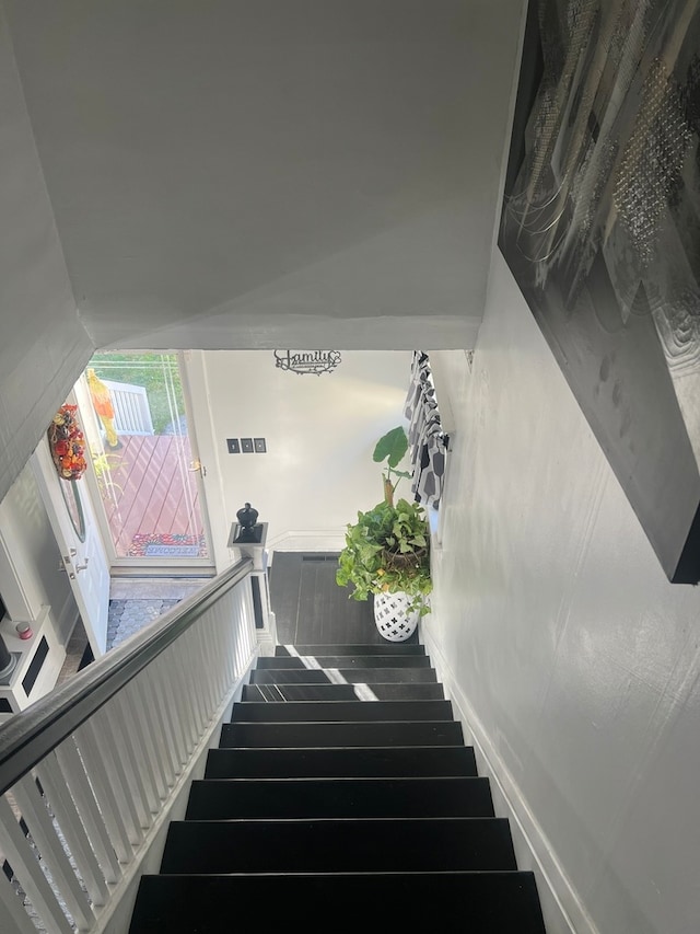 staircase with hardwood / wood-style floors