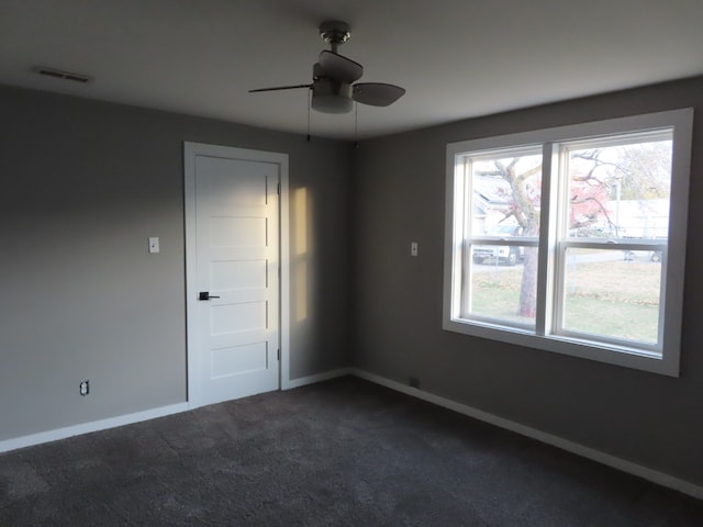 carpeted empty room featuring ceiling fan