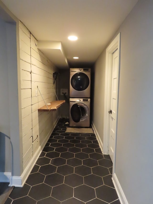 laundry area with stacked washer and clothes dryer