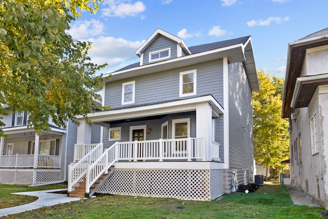 view of front facade featuring a front lawn and covered porch