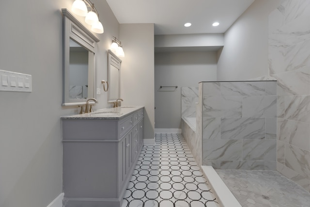 bathroom with tiled shower and vanity