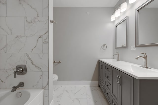 full bathroom with vanity, tiled shower / bath combo, and toilet