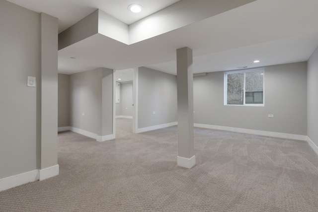 basement featuring light colored carpet