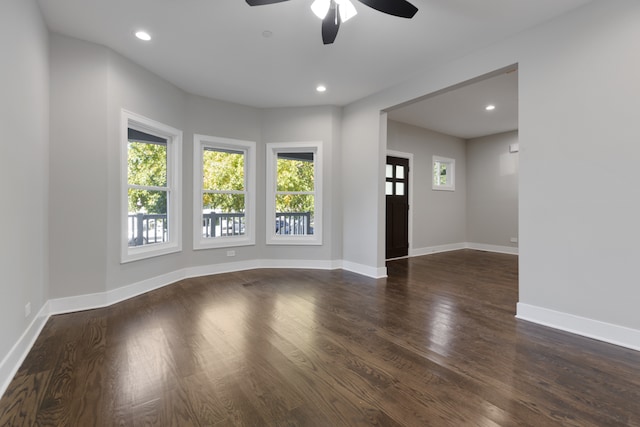 unfurnished room with dark hardwood / wood-style floors and ceiling fan