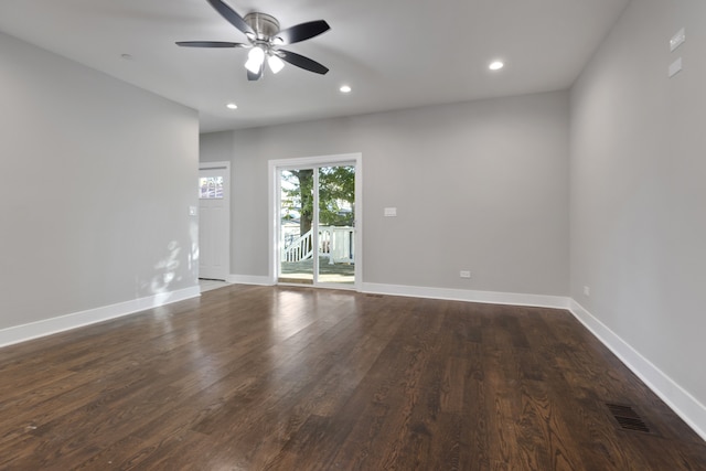 empty room with ceiling fan and dark wood-type flooring