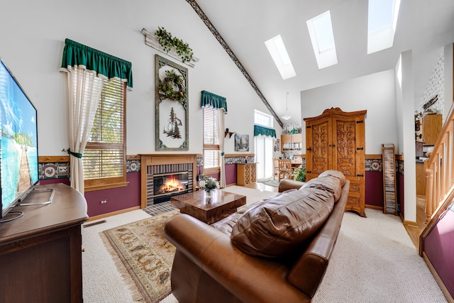 carpeted living room with a healthy amount of sunlight, high vaulted ceiling, and a fireplace